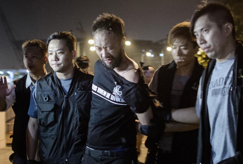 Ken Tsang being carried away by police.