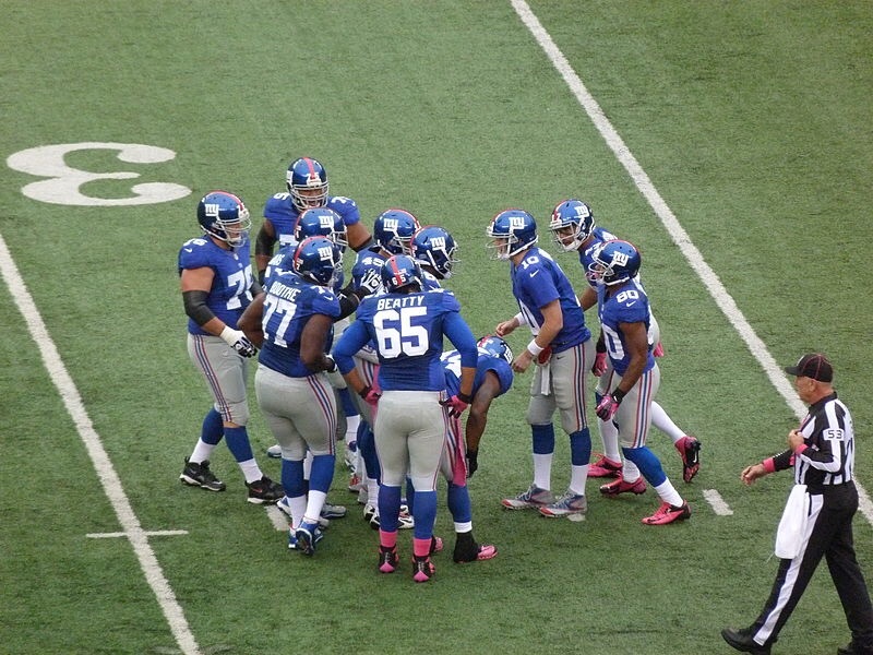 The New York Giants Huddle on Field