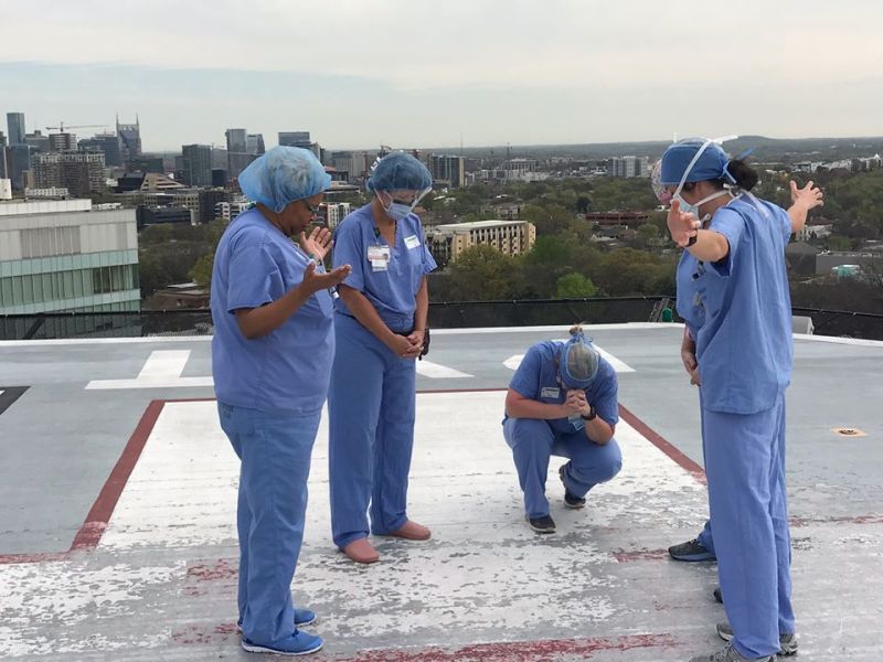 Angela Gleaves and her fellow nurses praying on the rooftop