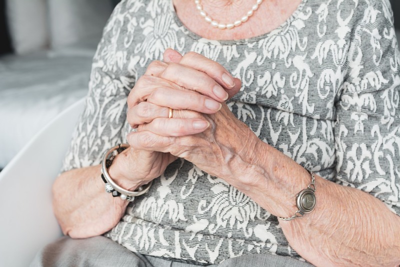An Old woman holds her hands. This picture isn't related with this article.