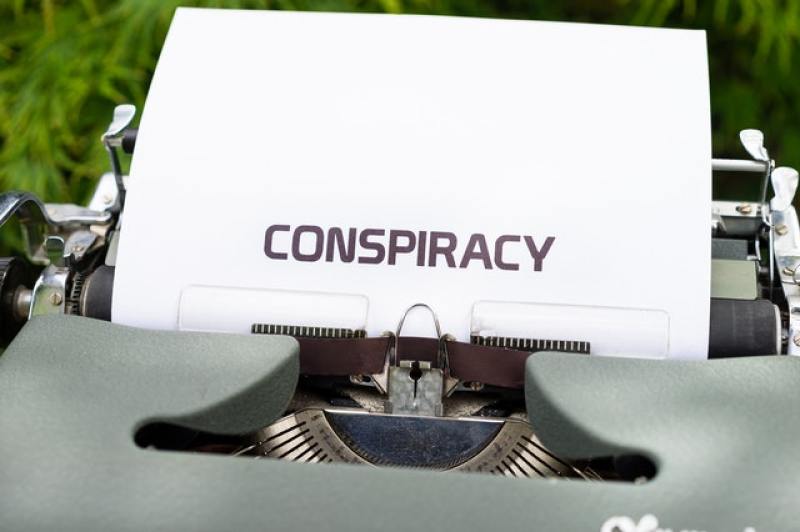 The word "conspiracy" typewritten on a piece of paper