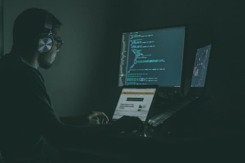 Man using computer in the dark