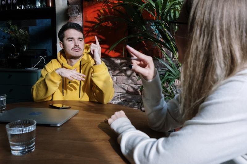 two people communicating via sign language