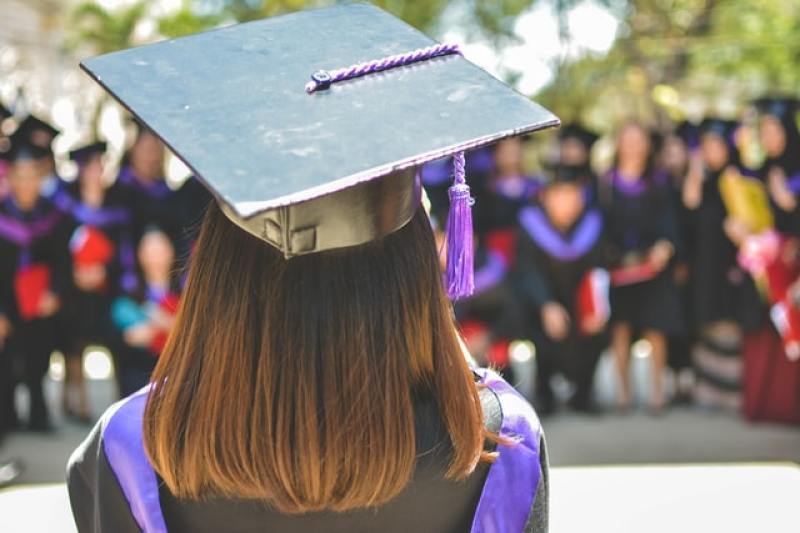 woman wearing academic cap and dress graduation student