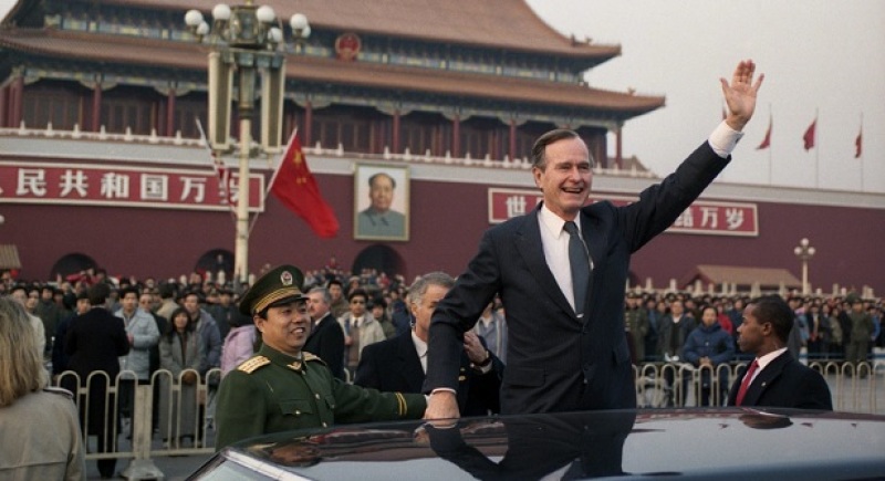 Former President George H. W. Bush waves to crowds in Beijing, February 1989