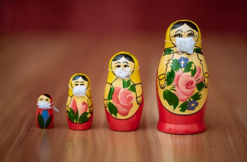 Russian matryoshka dolls, each of them having its own face mask