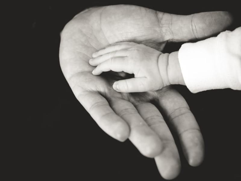 Baby and father's hand