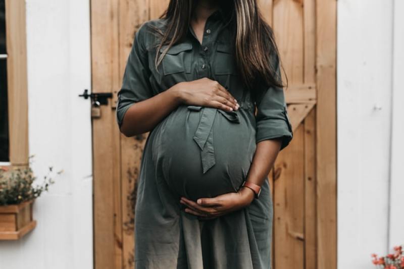 pregnant mom proudly showing her healthy baby bump