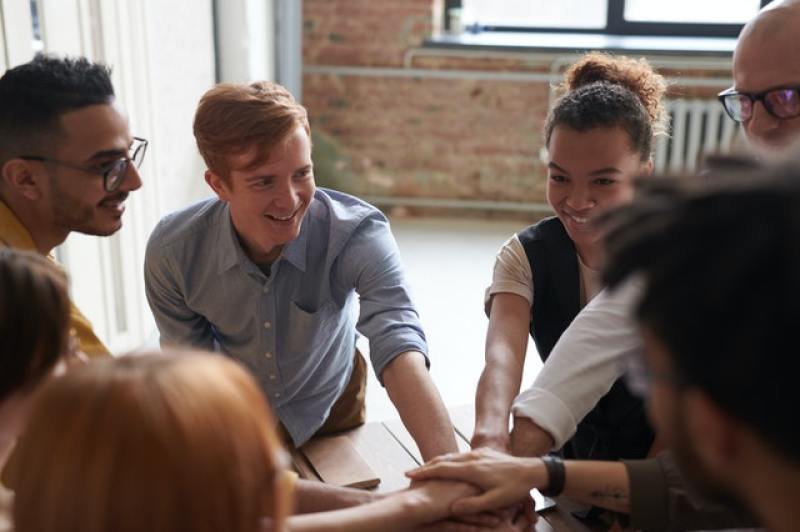 group of people joining their hands together