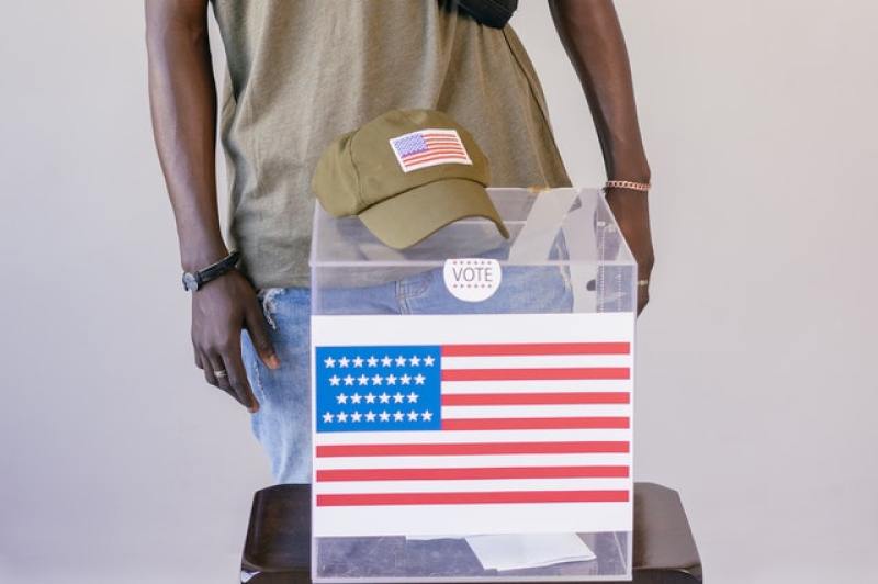 voter in front of ballot box
