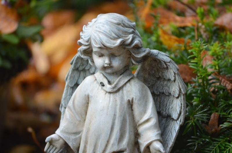 statue of a little child with wings like an angel