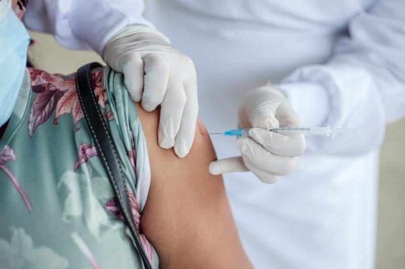 person getting injected with a vaccine