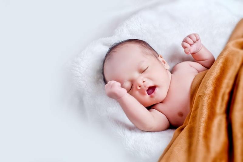 baby lying in soft bedding