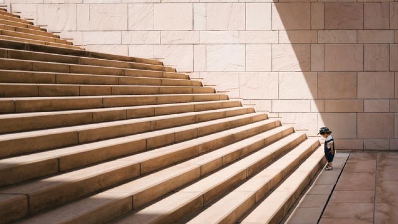 kid facing long staircase