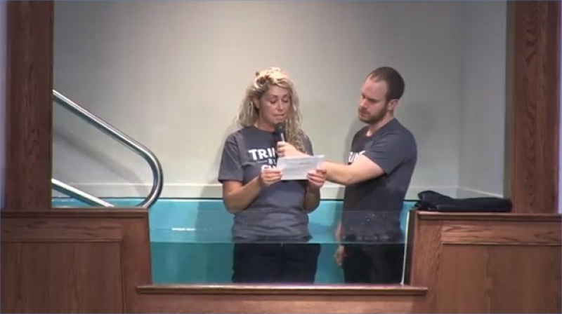 Water baptism of a former drug addict at Trinity Bible Chapel, which defied lockdown orders