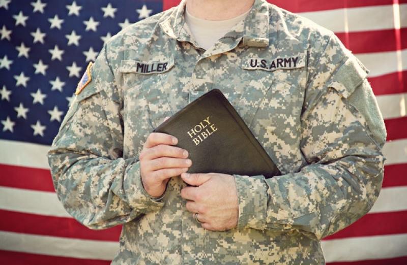 US Army member holding a Bible