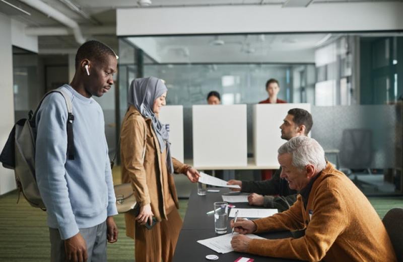 people casting ballots in a voting center