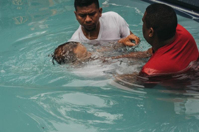 Christian baptism by immersion in pool of water