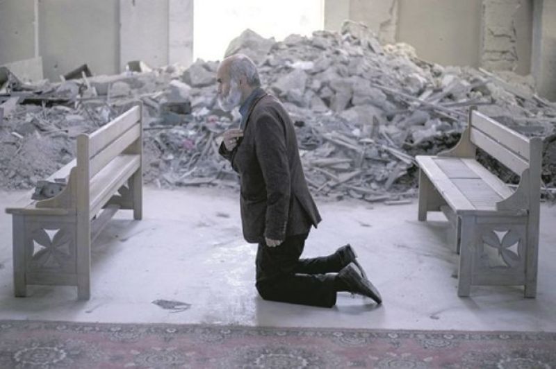 A man prays in a collapsed church in Shusa, Azerbaijan.