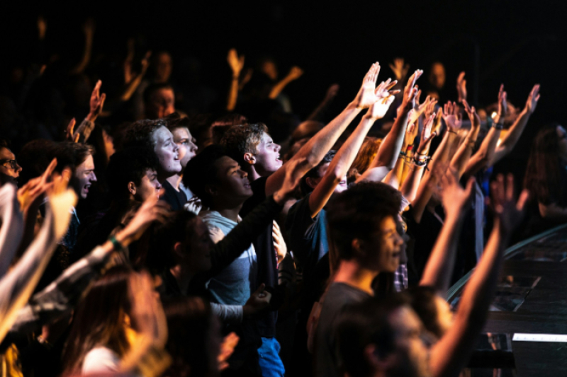 Church members are raising their hands in worship.